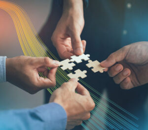 Business professionals connecting puzzle pieces to symbolize teamwork ans tailored solutions.